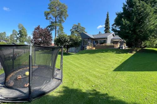 a trampoline in a yard in front of a house at Stor enebolig med høy standard in Tønsberg
