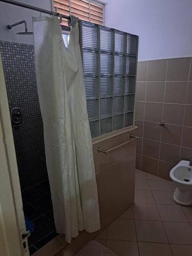a bathroom with a shower and a toilet at Kaya Ka hina in Xai-Xai