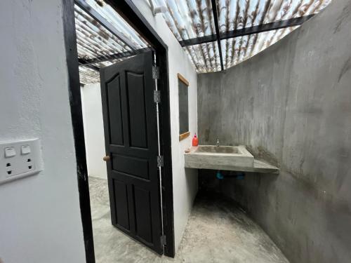 an open door to a bathroom with a sink at Paradise Sunset Beach in Koh Rong Sanloem