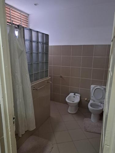 a bathroom with a toilet and a bidet at Kaya Ka hina in Xai-Xai