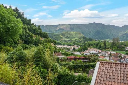 a view of a small town in the mountains at Cozy House in Furnas with Mountain View in Furnas