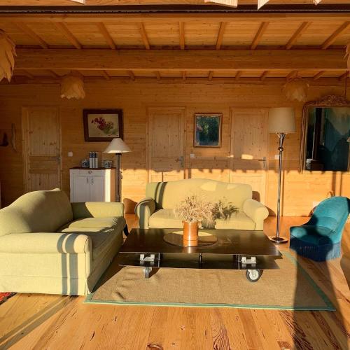 a living room with a couch and a table at Country Lodge in Les Épasses