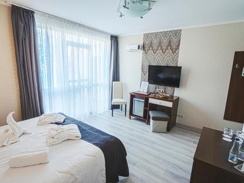 a hotel room with a bed and a television at Holiday Beach Budapest Wellness Hotel with Sauna Park in Budapest