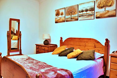 a bedroom with two beds and a mirror at Green Grove Guest House in St Julian's