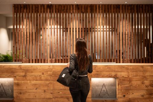 a woman standing in front of a organ at ADEA Lifestyle Suites Fieberbrunn in Fieberbrunn
