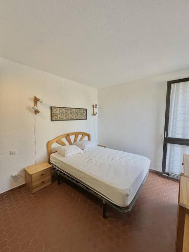 une chambre avec un lit dans une pièce avec une fenêtre dans l'établissement Accès direct plage - parking privé - appartement 4 personnes 4MIR7BAT8, au Barcarès