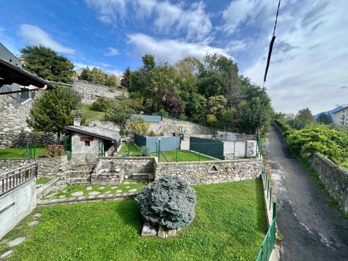 a garden with a bush in the grass at Aosta Holiday Apartments - Monte Zerbion in Aosta