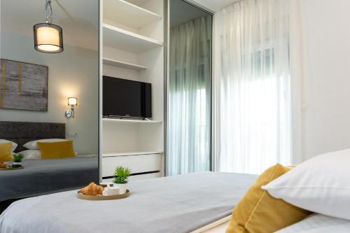 a bedroom with a mirror and a bed with a tv at "Casa Mia" Luxury villa with heated swimming pool with jacuzzi in Šestanovac
