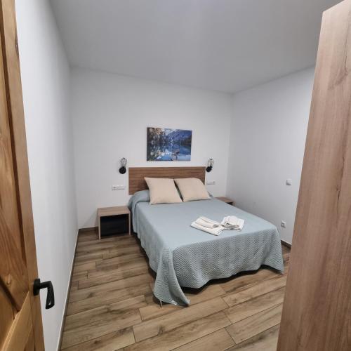 a bedroom with a bed in a white room at Utopia in Puigventos