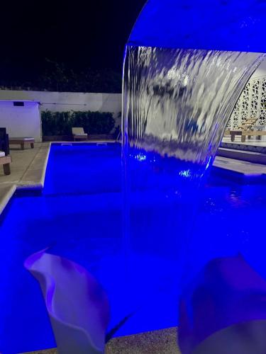 a water fountain in a pool at night at Résidence Turpin in Toubab Dialaw