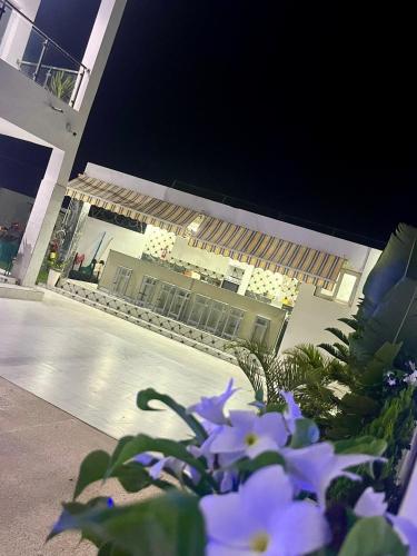 a building with purple flowers in front of it at Résidence Turpin in Toubab Dialaw