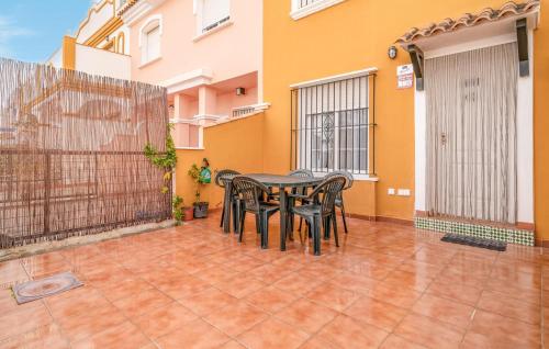 a patio with a table and chairs in front of a building at Awesome Home In San Juan De Los Terrer in San Juan de los Terreros
