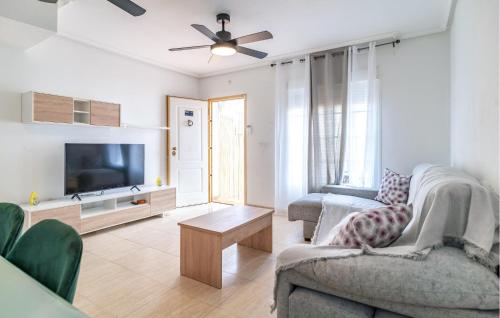 a living room with a couch and a tv at Awesome Home In San Juan De Los Terrer in San Juan de los Terreros