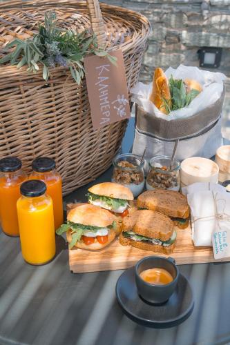 a table with sandwiches and drinks and baskets of food at Sigma Residences Boutique Hotel in Exámbela