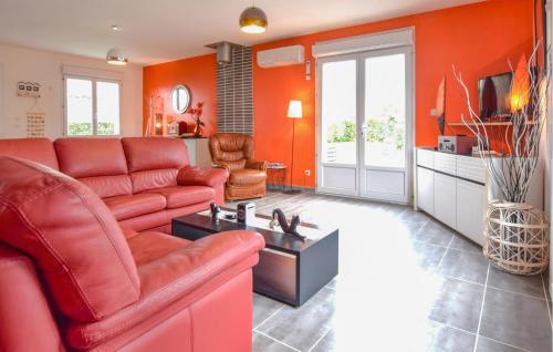 un salon avec des murs orange et un canapé rouge dans l'établissement Beautiful Home In Auberville With Wifi, à Auberville