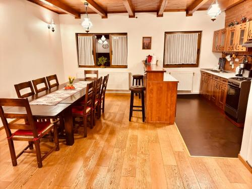 a kitchen and dining room with a table and chairs at Hillside Praid in Praid
