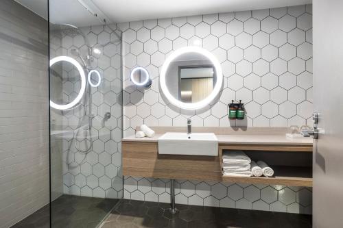 a bathroom with a sink and a mirror at Crowne Plaza Alice Springs Lasseters by IHG in Alice Springs