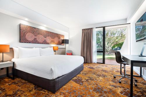 a hotel room with a bed and a desk at Crowne Plaza Alice Springs Lasseters by IHG in Alice Springs