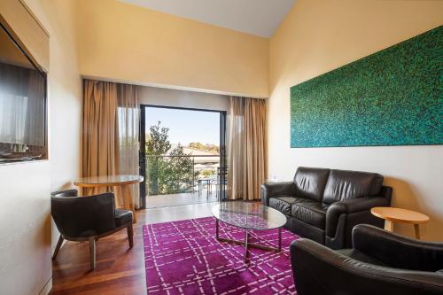 a living room with a couch and a table at Crowne Plaza Alice Springs Lasseters by IHG in Alice Springs