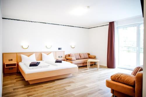 a bedroom with a large bed and a couch at Smart Resorts B&B2 BB2 308 in Winterberg