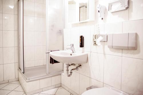 a white bathroom with a sink and a toilet at Smart Resorts B&B2 BB2 308 in Winterberg