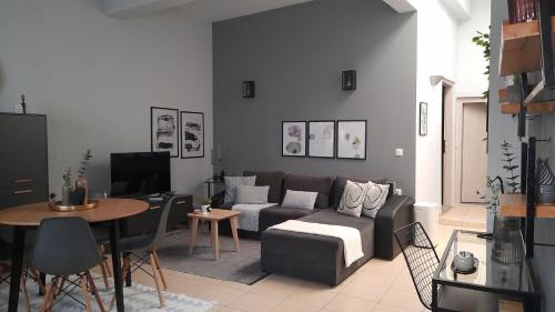 a living room with a couch and a table at Apt22 stylish apartment close of Heraklion center in Heraklio Town