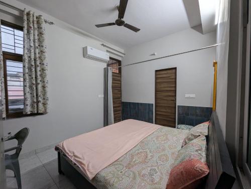 a bedroom with a bed and a ceiling fan at Jaisal Castle Homestay in Jaipur