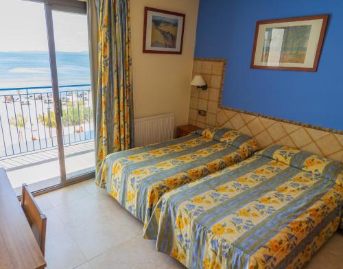 Postel nebo postele na pokoji v ubytování Hotel Marian Platja