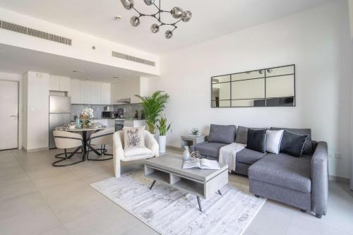 a living room with a couch and a table at Frank Porter - Lamtara 3 in Dubai