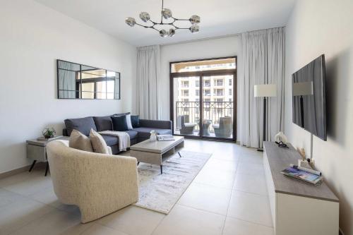 a living room with a couch and a table at Frank Porter - Lamtara 3 in Dubai