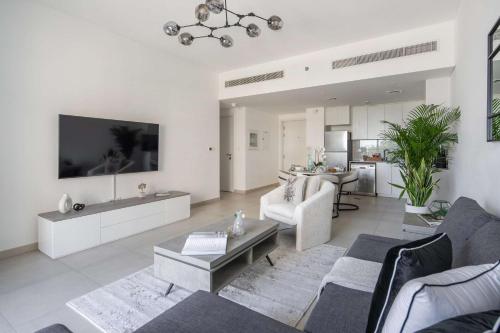 a living room with a couch and a table at Frank Porter - Lamtara 3 in Dubai