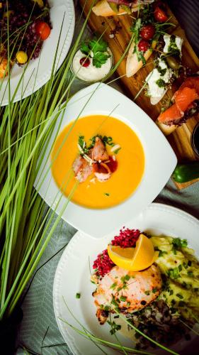a table with three plates of food on it at Kolonna Hotel Brigita in Rīga