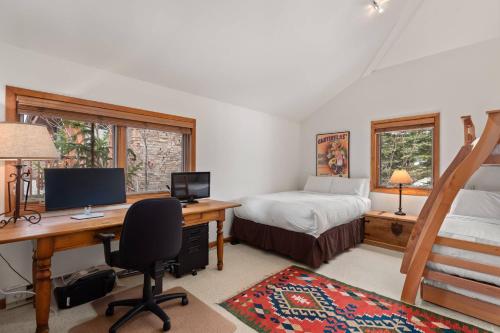 a bedroom with a desk with a computer and a bed at Ridge 27 in Snowmass Village