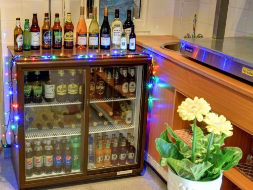 a refrigerator filled with lots of bottles of alcohol at YHA Beer in Seaton