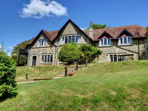 an old stone house on a grassy hill at YHA Beer in Seaton