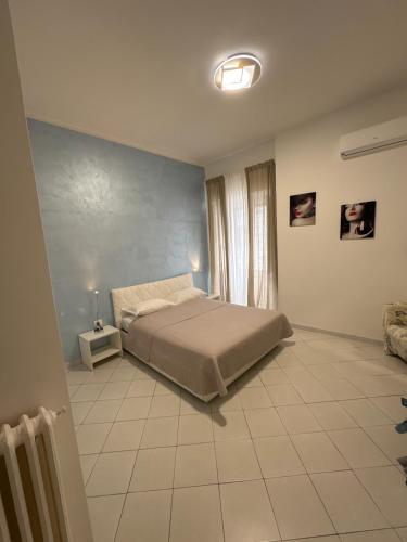 a bedroom with a bed and a tiled floor at Grillo in Salerno