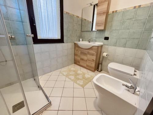 a bathroom with a sink and a toilet and a shower at Villa Giulia in Is Molas 