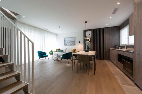 a kitchen and dining room with a table and chairs at The Central City - Luxury Serviced Residence in Luxembourg