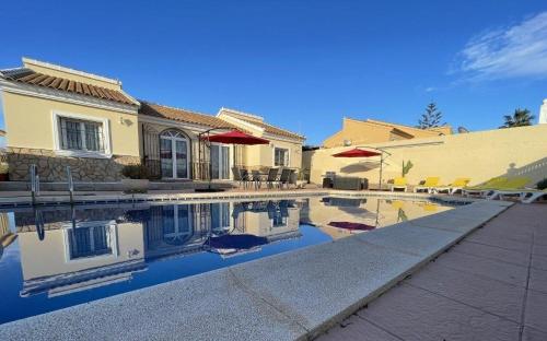 a house with a swimming pool in front of a house at Llanos del Peral - Zurgena - sleeps 6 - R092 in Zurgena