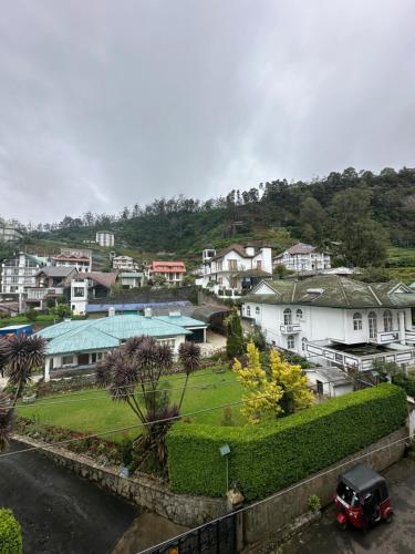 a view of a town with houses and a street at Mariners Cabin Apartment in Nuwara Eliya