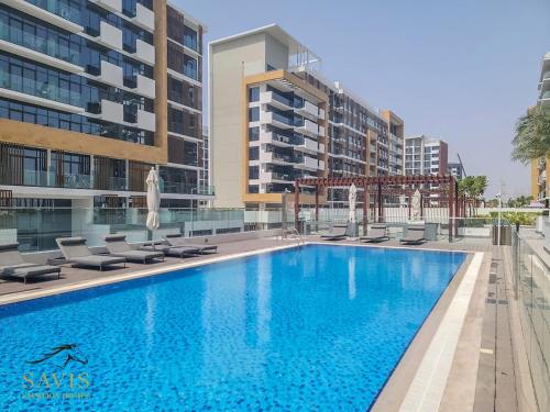 a swimming pool in the middle of a building at A Modern Haven Cozy Studio in Azizi Riviera Meydan in Dubai