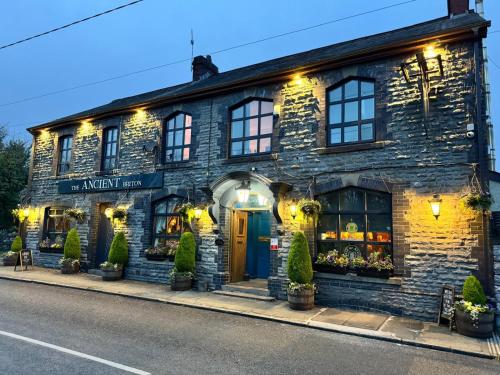 an old stone building with a store on the street at The Ancient Briton in Pen-y-cae
