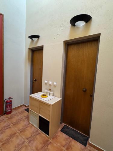 a room with a bathroom with a sink and two doors at Frigias 2 in Arachova