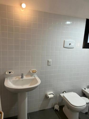 a bathroom with a sink and a toilet at Casa de la Flor by Posada de la Flor in Colonia del Sacramento