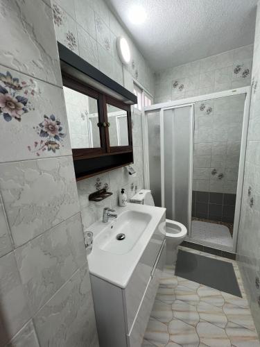 a white bathroom with a sink and a shower at Casa Playa Paraiso Manilva in Manilva
