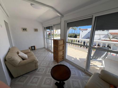 a living room with a couch and a balcony at Casa Playa Paraiso Manilva in Manilva