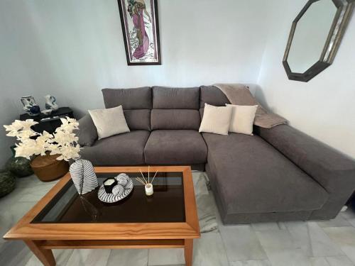 a living room with a couch and a coffee table at Casa Playa Paraiso Manilva in Manilva