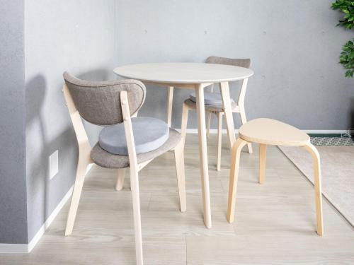 a table and two chairs and a table and stool at Stellar Nishi-Kojiya in Tokyo