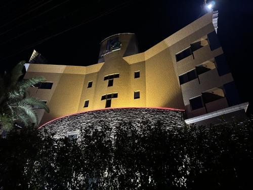 a building with a clock tower at night at ホテルk2 in Itoshima