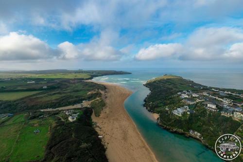 an aerial view of a beach and the ocean at The Lucky Shamrock Caravan - by stunning, Crantock Beach in Crantock